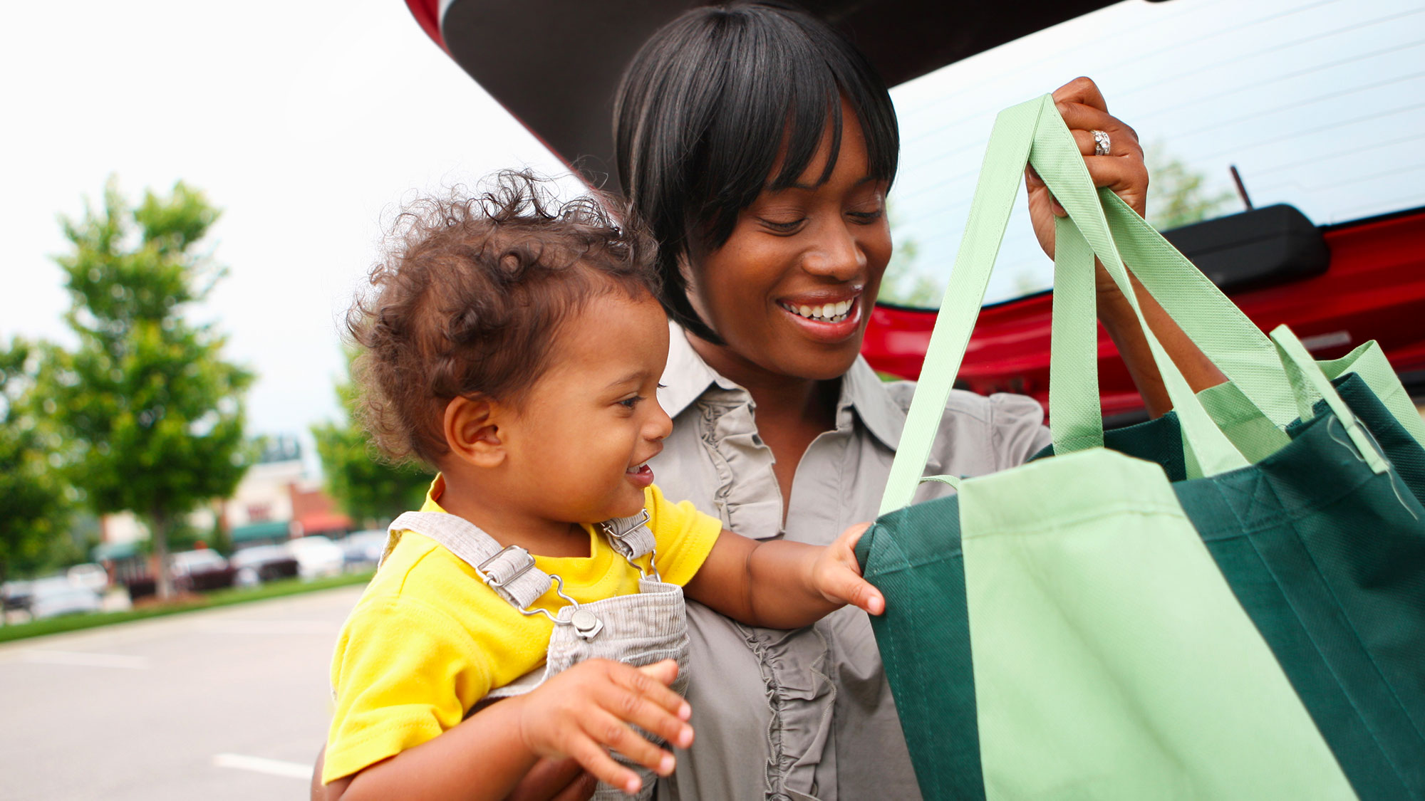 Woman-And-Baby-Loading-Grocery-Tote-Bags